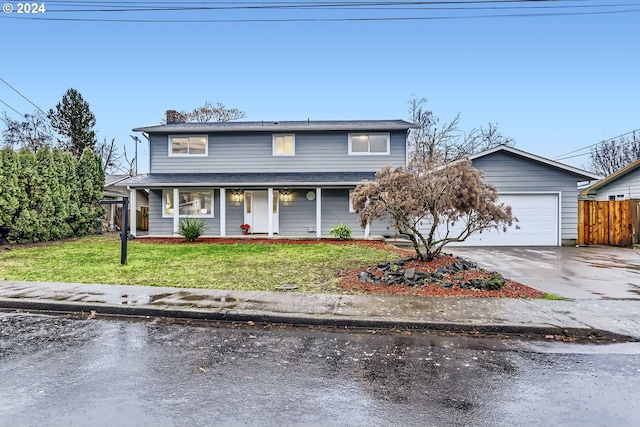 view of property featuring a front yard and a garage