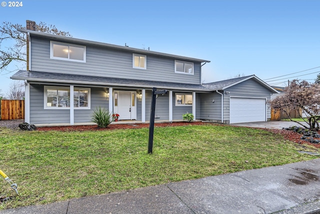 view of property with a garage and a front yard