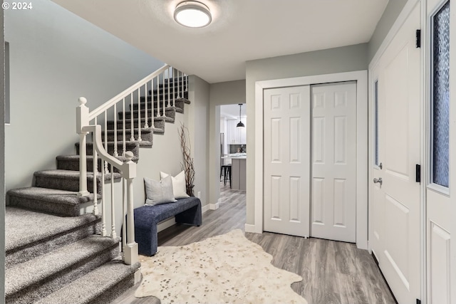 stairs featuring hardwood / wood-style floors