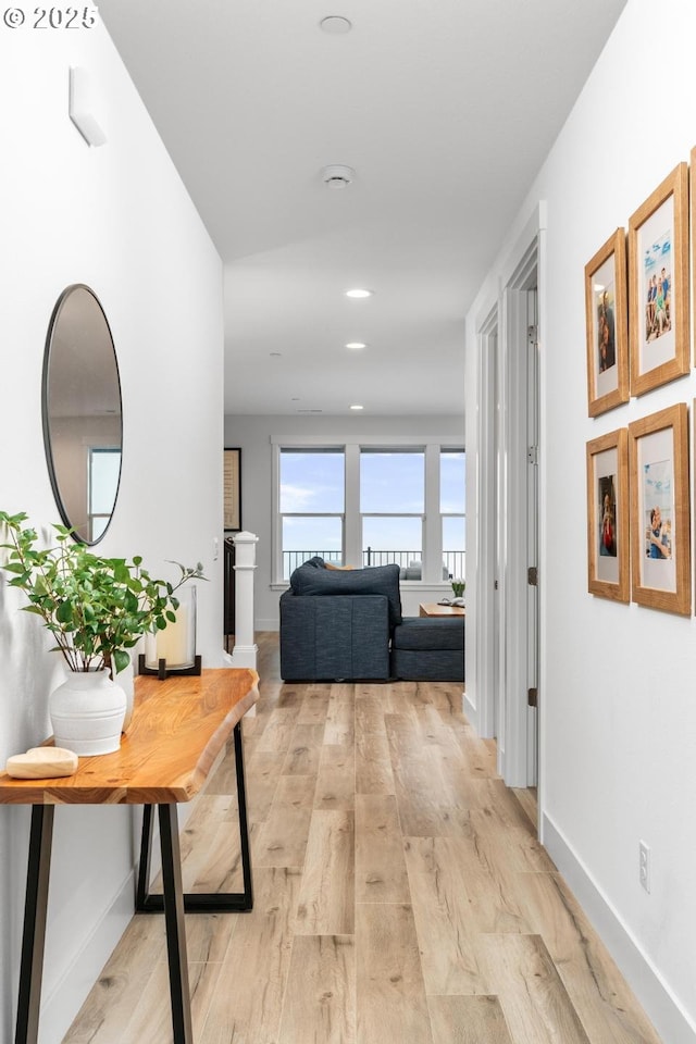 hallway with light hardwood / wood-style floors