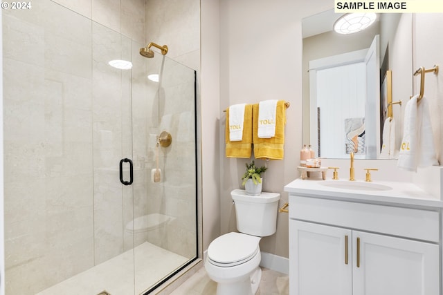 bathroom with vanity, an enclosed shower, and toilet