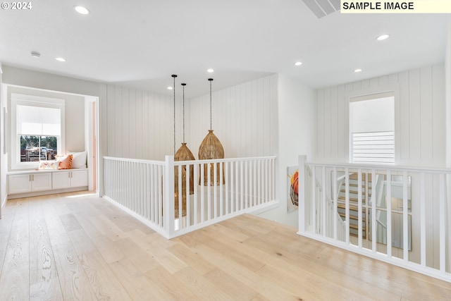 corridor with light hardwood / wood-style flooring