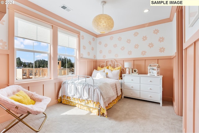 carpeted bedroom featuring crown molding