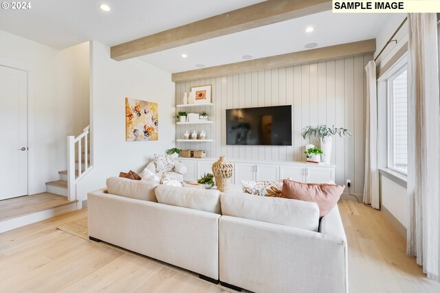 living room with beam ceiling and light hardwood / wood-style floors