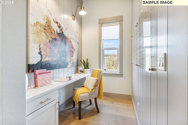 home office featuring built in desk and light wood-type flooring