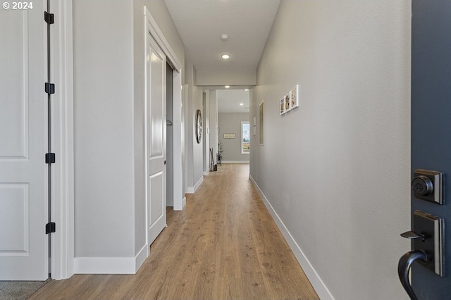 hallway with light hardwood / wood-style flooring