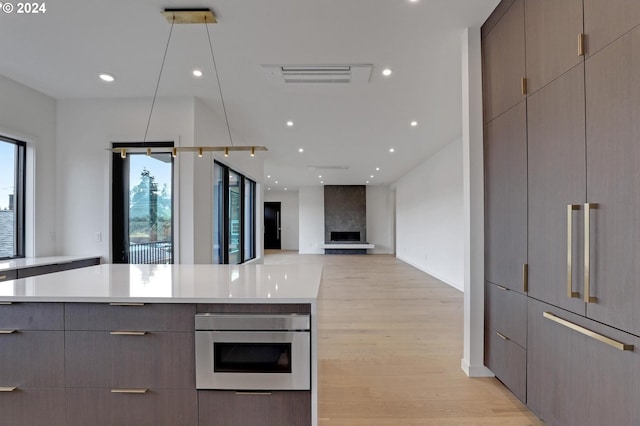 kitchen featuring light wood-type flooring, visible vents, modern cabinets, gray cabinetry, and light countertops