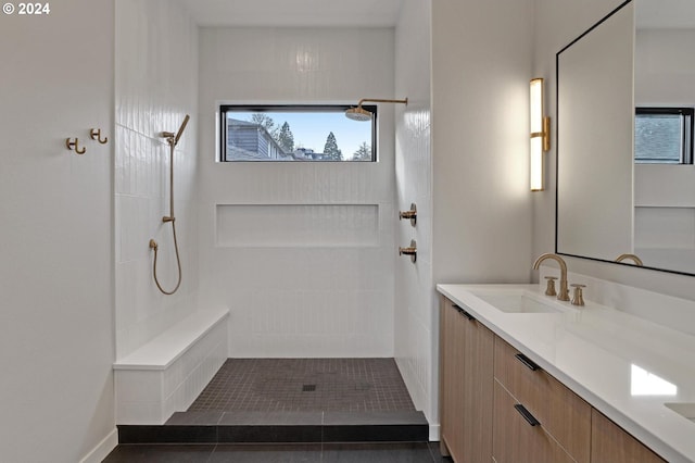bathroom featuring vanity and a tile shower