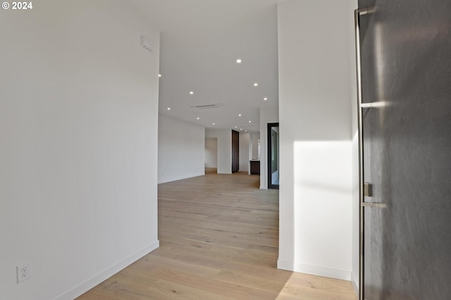 corridor with light wood-type flooring