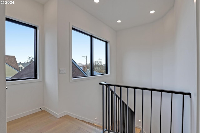 interior space featuring recessed lighting, wood finished floors, and baseboards