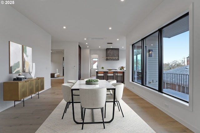 dining room featuring recessed lighting, light wood-style flooring, and baseboards