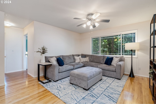 living room featuring ceiling fan and light hardwood / wood-style floors