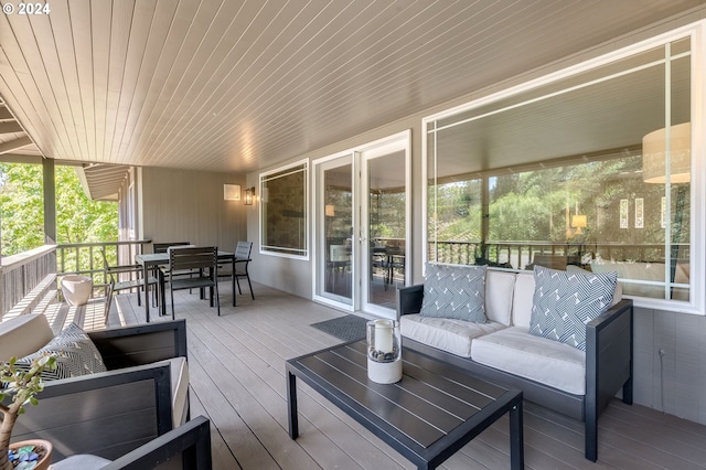 wooden terrace featuring an outdoor hangout area