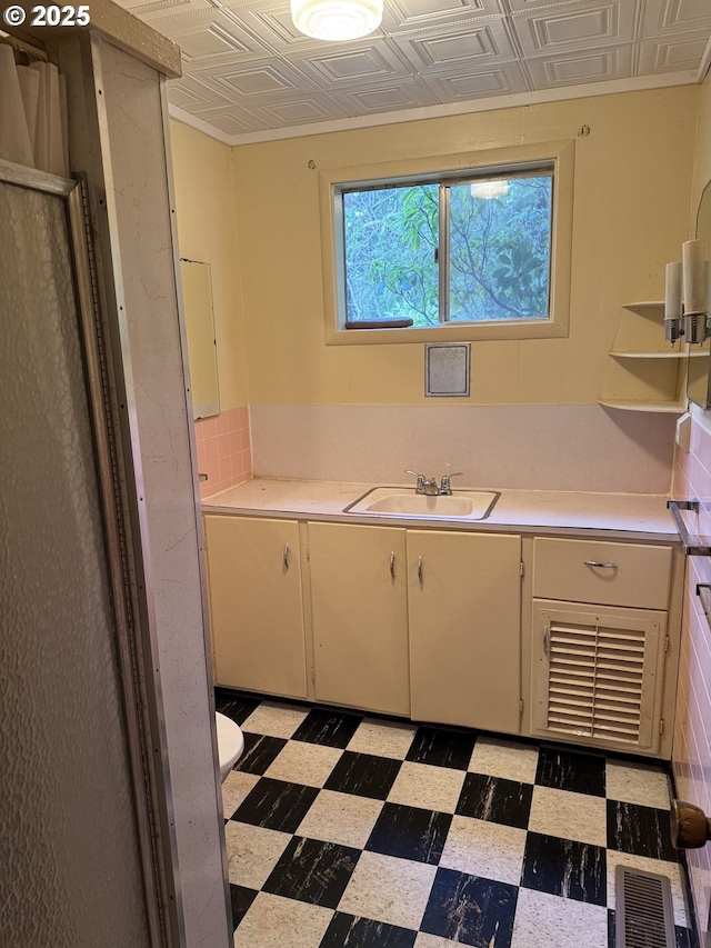 interior space featuring vanity and toilet