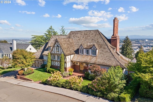 2868 NW Cumberland Rd, Portland, OR 97210 - tudor-style house featuring a chimney, brick siding, and stucco siding