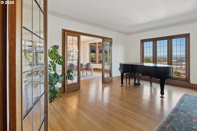 2868 NW Cumberland Rd, Portland, OR 97210 - sitting room with light wood-type flooring, ornamental molding, and french doors