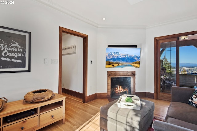 2868 NW Cumberland Rd, Portland, OR 97210 - living room featuring a warm lit fireplace, light wood-type flooring, ornamental molding, and recessed lighting