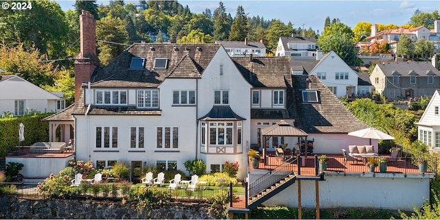 back of property featuring a wooden deck