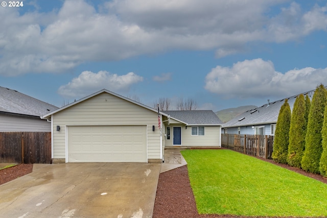 ranch-style house with a garage and a front lawn