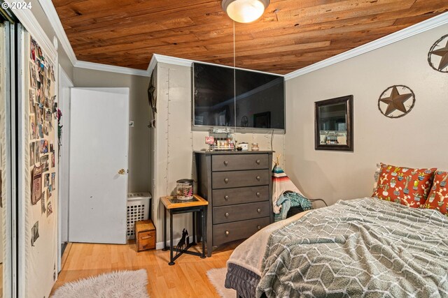 bedroom featuring ornamental molding, wood ceiling, and light hardwood / wood-style floors