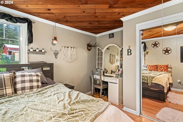 bedroom with crown molding, wood finished floors, wood ceiling, and baseboards