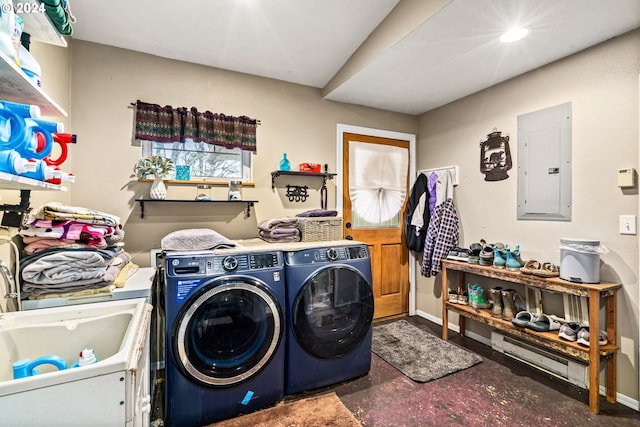 clothes washing area featuring baseboards, laundry area, electric panel, a sink, and washing machine and dryer