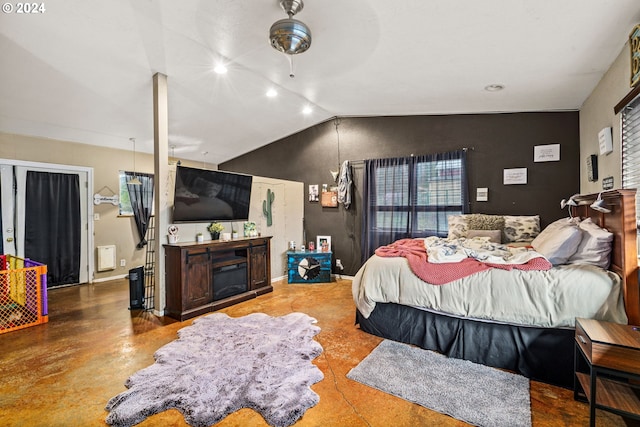 bedroom with baseboards, lofted ceiling, and a fireplace