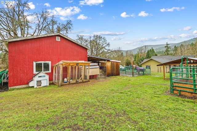 view of yard featuring a mountain view and an outbuilding