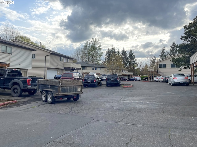 view of parking / parking lot with a garage