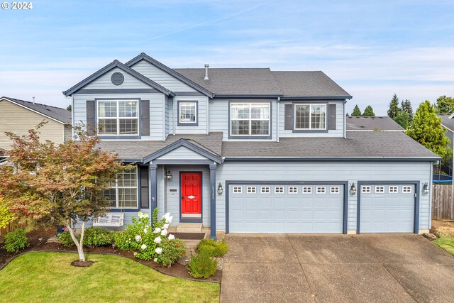 view of front of property featuring a garage and a front yard