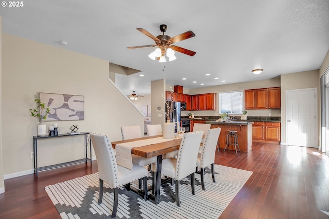 dining space featuring dark hardwood / wood-style floors and ceiling fan