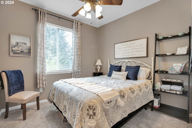 carpeted bedroom with ceiling fan and multiple windows