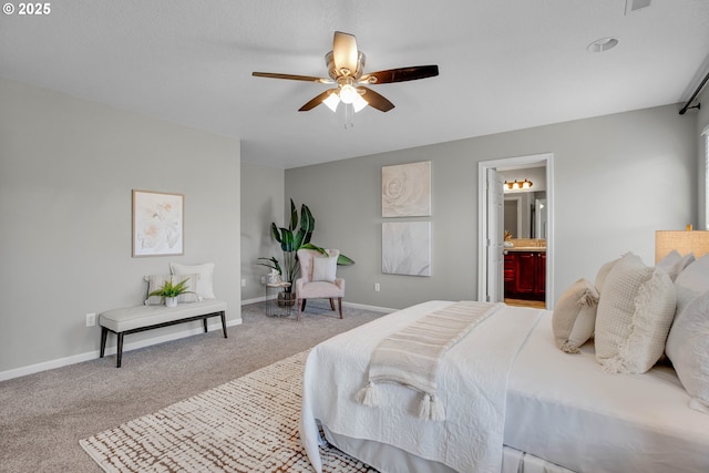 carpeted bedroom featuring ensuite bath and ceiling fan