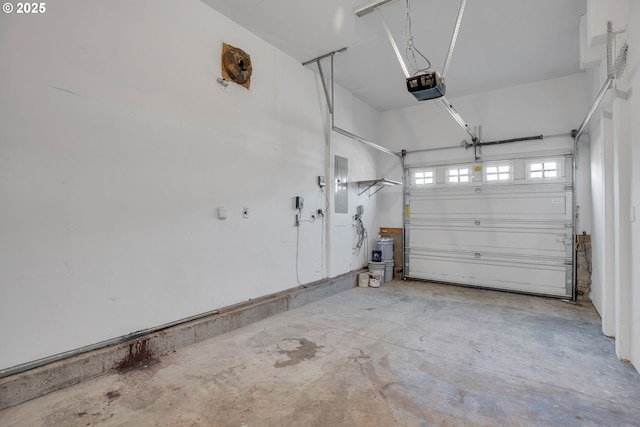 garage with a garage door opener and electric panel