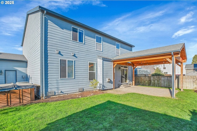 back of house featuring a patio and a yard