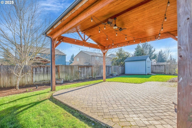 view of patio with a storage shed, a gazebo, and ceiling fan