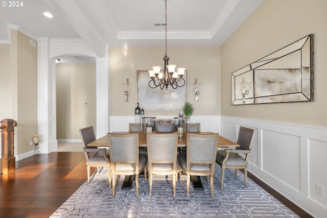 dining room with ornamental molding, wood-type flooring, and a notable chandelier