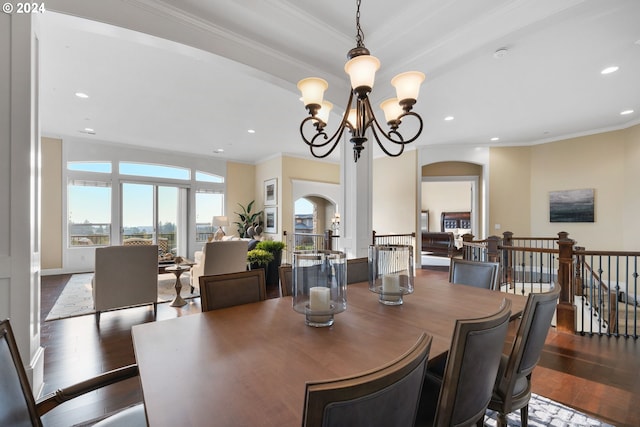 dining space with ornamental molding, dark hardwood / wood-style floors, and an inviting chandelier