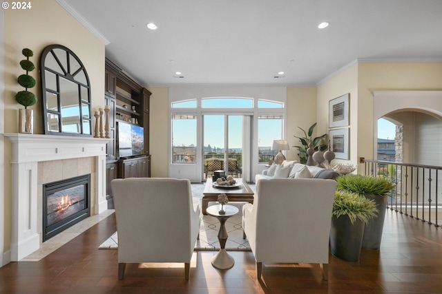 living room featuring a fireplace, dark hardwood / wood-style floors, crown molding, and a healthy amount of sunlight