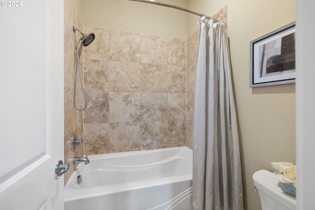 bathroom featuring toilet and shower / bath combo with shower curtain