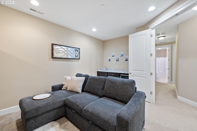 carpeted living room with wet bar