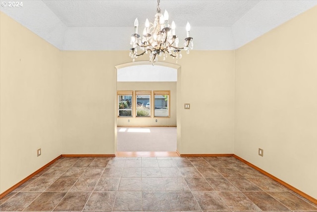 unfurnished dining area with a textured ceiling