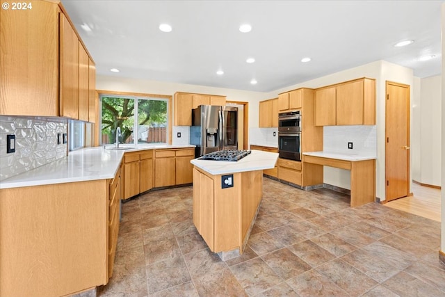 kitchen with appliances with stainless steel finishes, decorative backsplash, a kitchen island, and sink