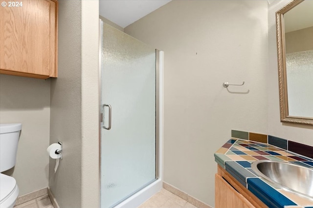 bathroom with walk in shower, tile patterned floors, vanity, and toilet