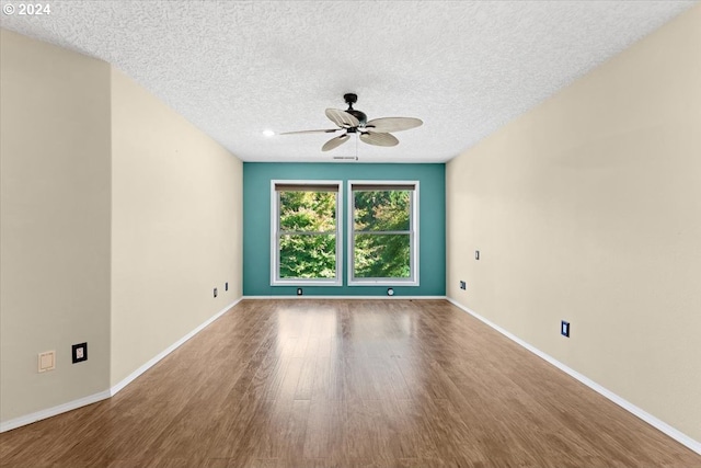 spare room with ceiling fan, hardwood / wood-style flooring, and a textured ceiling