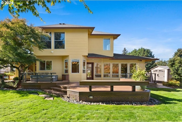 rear view of property with a wooden deck, a shed, and a lawn