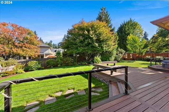 wooden terrace with a lawn and a shed