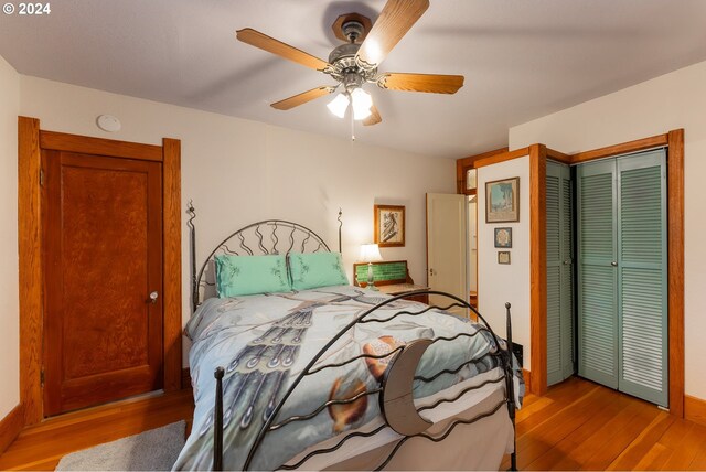 bedroom featuring ceiling fan, light hardwood / wood-style floors, and a closet