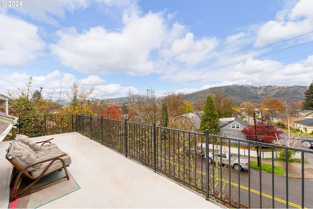 view of patio featuring a mountain view and a balcony