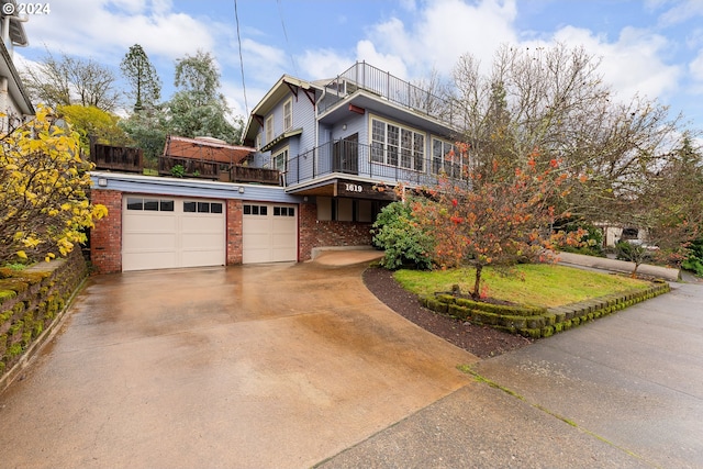 view of front facade with a garage and a balcony